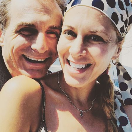 Peter Arpesella hugging his spouse, Annie Wood